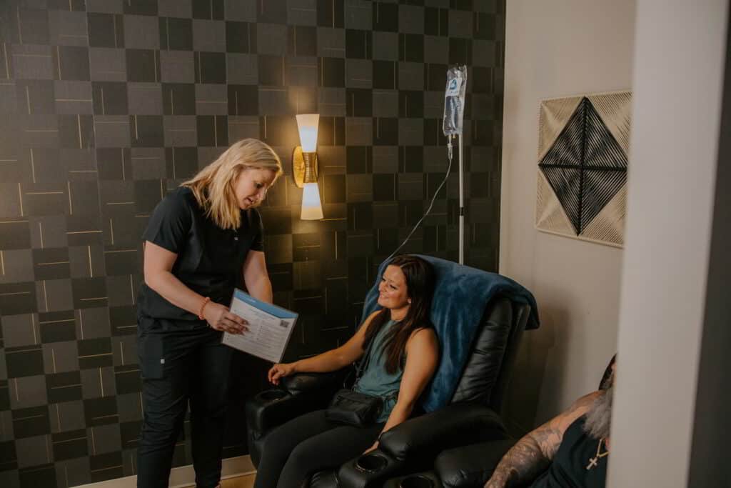 Vital Flow nurse talking with a client during an IV hydration visit in Sioux Falls.